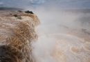 El Niño rains flood South America, sending residents fleeing and cattle swimming